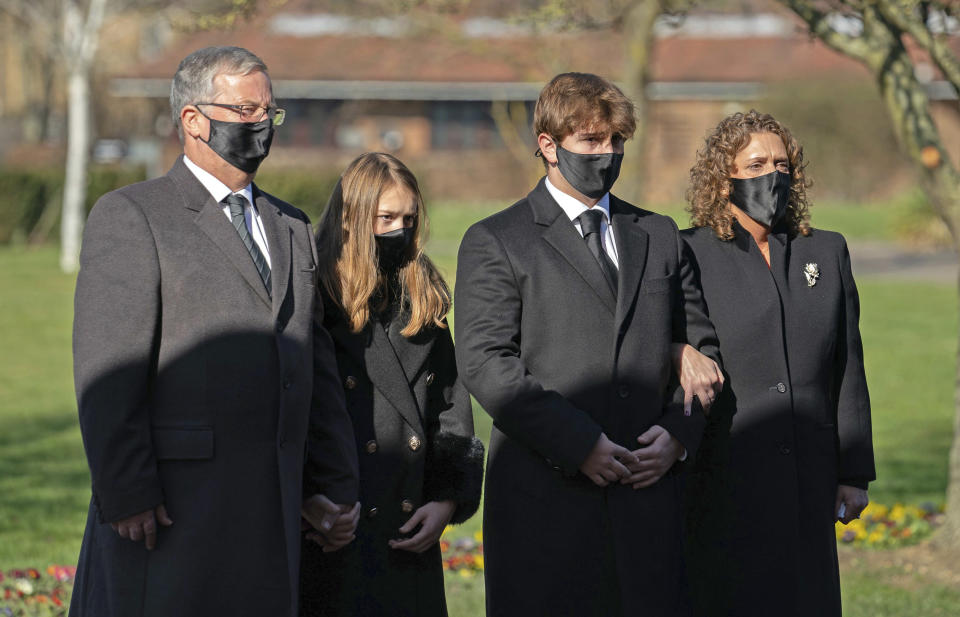 The family of Captain Tom Moore, from left, son-in-law Colin Ingram, granddaughter Georgia, grandson Benjie and daughter Hannah Ingram-Moore arrive for his funeral, at Bedford Crematorium, in Bedford, England, Saturday, Feb. 27, 2021. Tom Moore, the 100-year-old World War II veteran who captivated the British public in the early days of the coronavirus pandemic with his fundraising efforts died, Tuesday Feb. 2, 2021. (Joe Giddens/Pool Photo via AP)