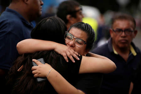 Women hug as rescue teams continue to search for people in the rubble of a collapsed building after an earthquake, in Mexico City, Mexico September 23, 2017. REUTERS/Jose Luis Gonzalez