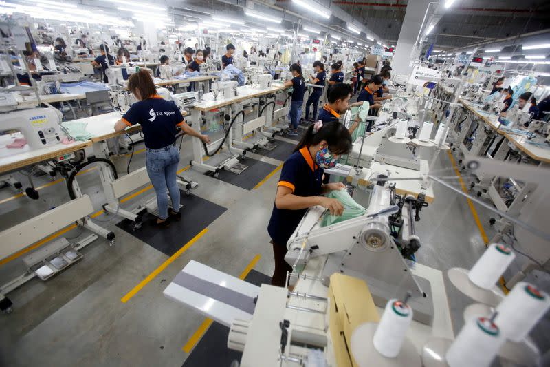 FILE PHOTO: Labourers work at TAL Apparel Vietnam Garments factory in Vinh Phuc province