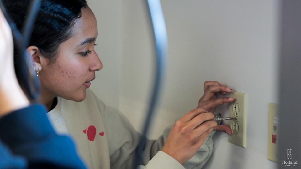 HYAC Environmental Committee member Eva Sampedro was part of the team that installed foam inserts in outlets and switches at Holland City Hall.