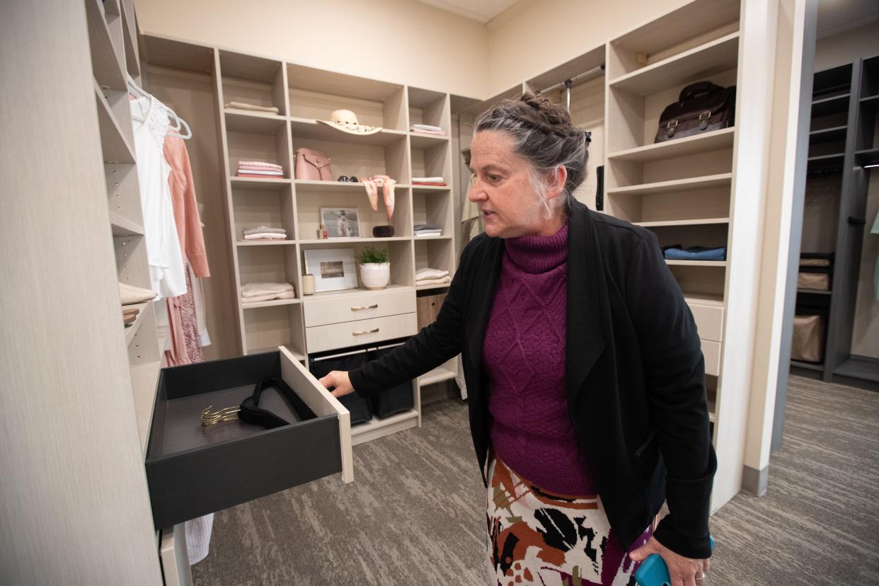 Closet specialist Linda Fisher shows off some of the unique features included in the showroom of a closet design at Pulito Closets.