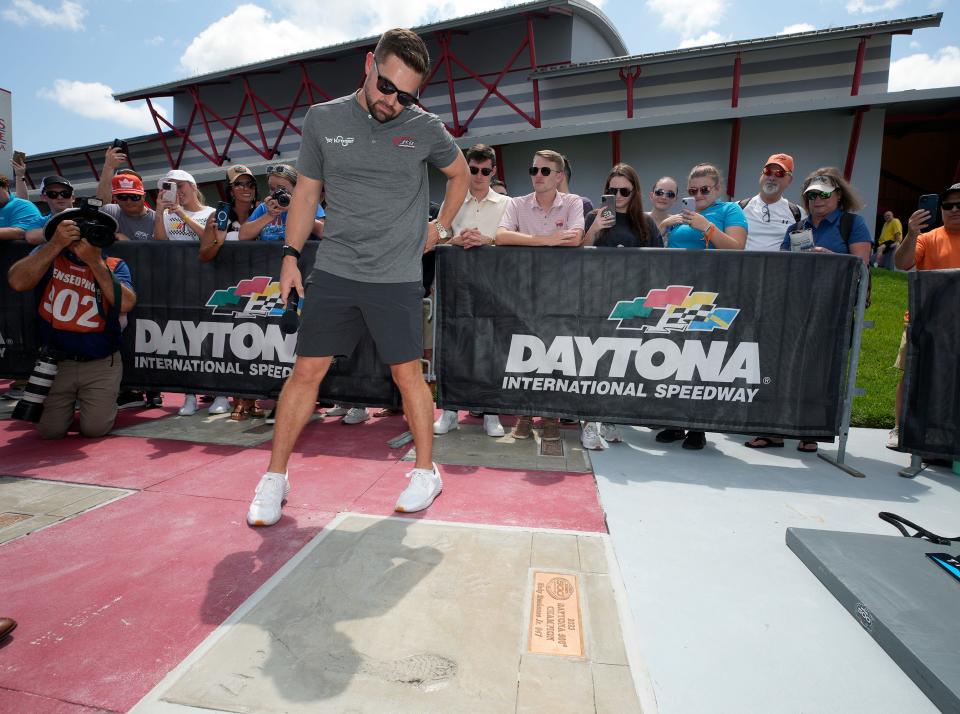 Ricky Stenhouse admires his "Walk of Fame" slab Friday at Daytona.