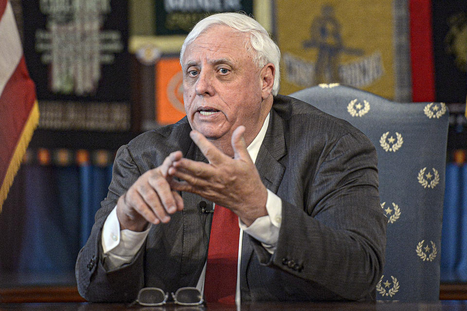 FILE - In this March 12, 2020, file photo, West Virginia Gov. Jim Justice speaks during a press conference at the State Capitol in Charleston, W.Va. The U.S. Department of Justice has weighed in on a new West Virginia law that bans transgender athletes from competing in female sports, asserting in a court filing Thursday, June 17, 2021, that the ban violates federal law. Justice signed the bill despite warnings from some lawmakers that the NCAA could retaliate and decide not to hold college tournaments in the state. Justice had said that while it concerned him that the state could miss out on a sporting event, he believed the benefits of the law “way outweigh the bad part of it.” (F. Brian Ferguson/Charleston Gazette-Mail via AP, File)