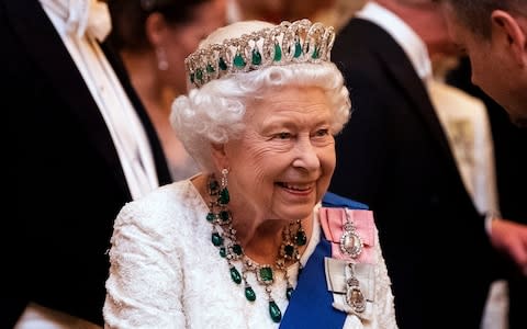 Queen Elizabeth II talks to guests at an evening reception for members of the Diplomatic Corps at Buckingham Palace in London - Credit: Victoria Jones&nbsp;/PA