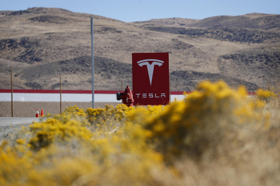 In this Oct. 13, 2018, photo, a sign marks the entrance to the Tesla Gigafactory in Sparks, Nev. A population inrush to Nevada has been driven by people seeking more affordable housing and a growing tech industry around Reno. (AP Photo/John Locher)