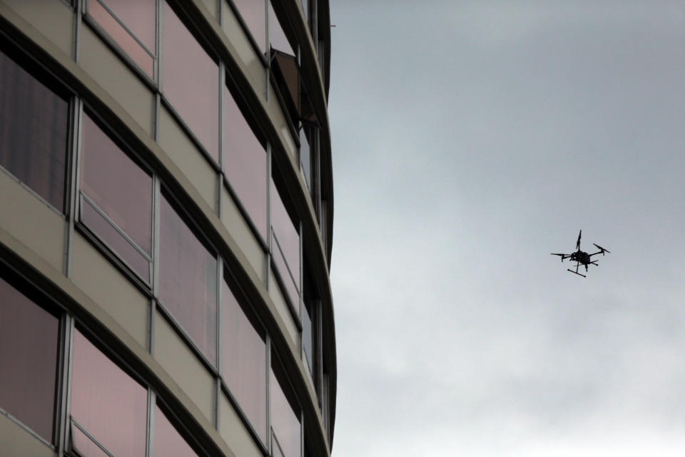 Police respond to a report of gunfire at Smith Tower Apartments in downtown Vancouver, Wash., on Thursday, Oct. 3, 2019. A man opened fire Thursday in the lobby of an apartment building for seniors, striking several people, authorities said. (Mark Graves/The Oregonian via AP)