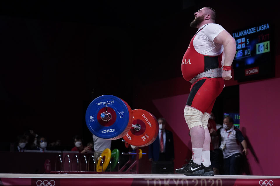 Lasha Talakhadze of Georgia celebrates after winning gold in the men's +109kg weightlifting event, at the 2020 Summer Olympics, Wednesday, Aug. 4, 2021, in Tokyo, Japan. (AP Photo/Seth Wenig)