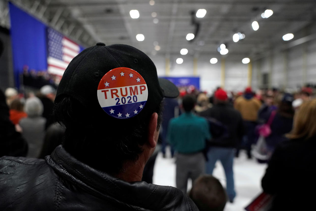 A man wears a Trump 2020 campaign button as U.S. President Donald Trump speaks in support of Republican congressional candidate Rick Saccone during a Make America Great Again rally in Moon Township, Pennsylvania, U.S., March 10, 2018.      REUTERS/Joshua Roberts