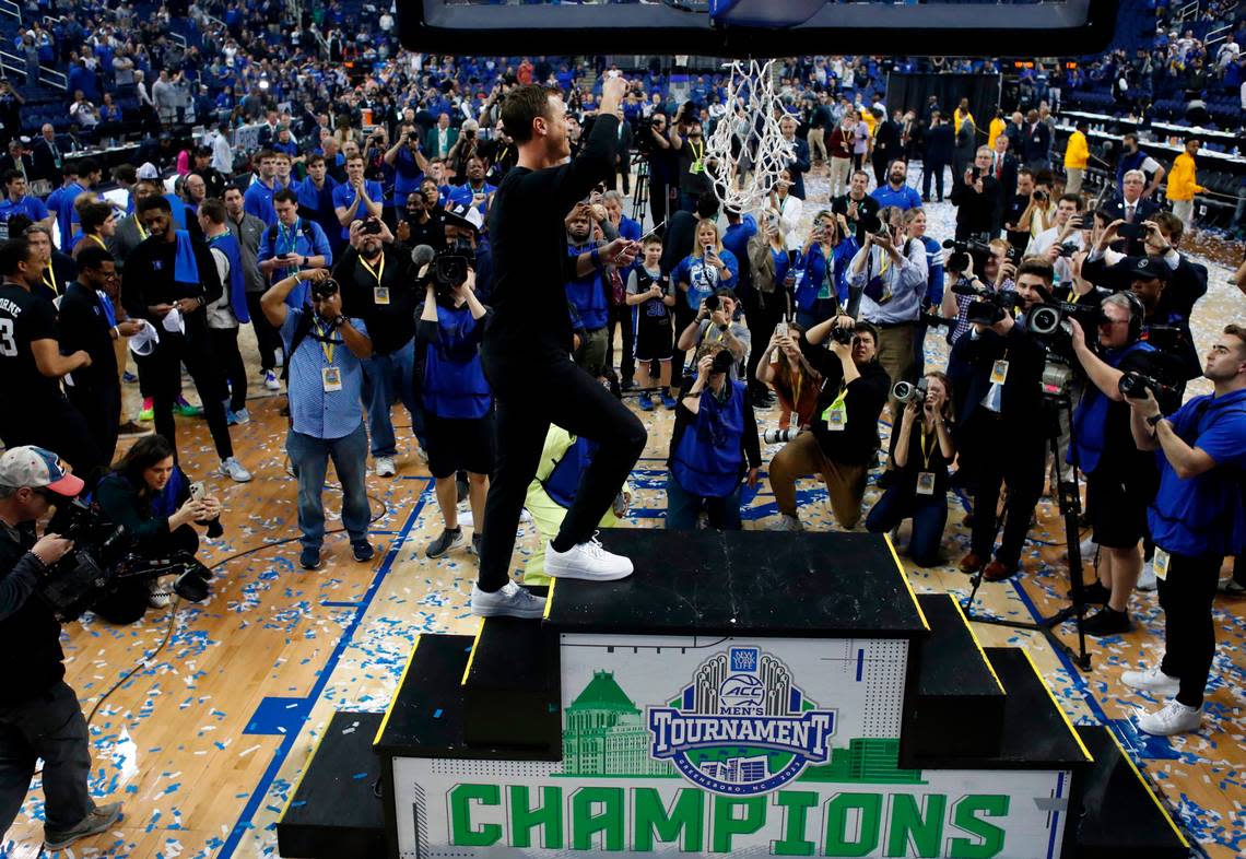 Duke head coach Jon Scheyer celebrates as he climbs the stairs to cut down the net after Duke’s 59-49 victory over Virginia to win the ACC Men’s Basketball Tournament in Greensboro, N.C., Saturday, March 11, 2023.