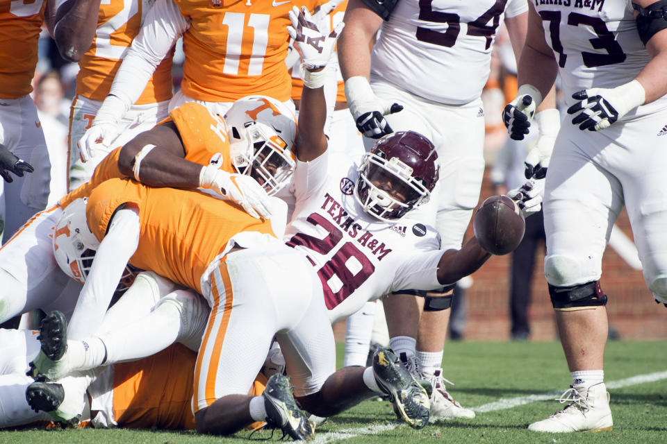 Texas A&M running back Isaiah Spiller (28) celebrates a touchdown against Tennessee during an NCAA college football game in Neyland Stadium in Knoxville, Tenn., Saturday, Dec. 19, 2020. (Brianna Paciorka/Knoxville News Sentinel via AP, Pool)