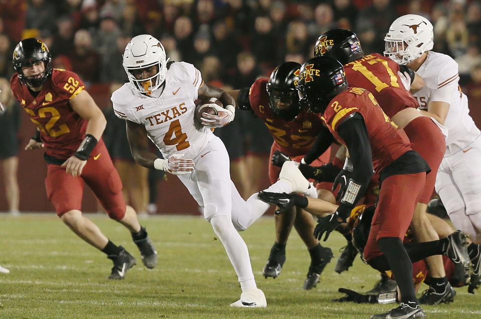 Texas' CJ Baxter (4) runs for a first down against Iowa State during Saturday's game at Jack Trice Stadium.