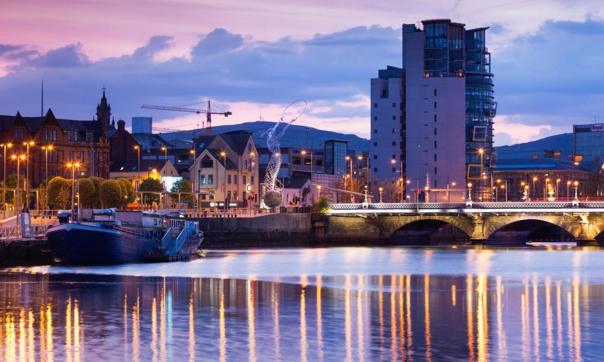 <span>Belfast skyline along River Lagan at dusk.</span><span>Photograph: Walter Bibikow/Getty Images</span>