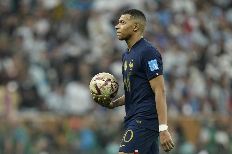 FILE - France's Kylian Mbappe carries the ball to take his shot during a penalty shootout at the end of the World Cup final soccer match between Argentina and France at the Lusail Stadium in Lusail, Qatar, Sunday, Dec. 18, 2022. Kylian Mbappe, who has 104 million followers on Instagram and more than 12 million followers on Twitter, was subjected to racial abuse along with fellow Black teammate Kingsley Coman after their French national team lost in the 2022 World Cup final to Argentina. (AP Photo/Martin Meissner, File)