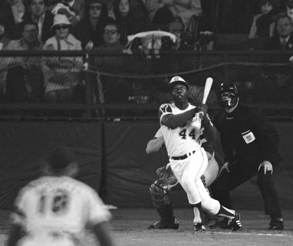 FILE - In this April 8, 1974 file photo, Atlanta Braves' Hank Aaron eyes the flight of the ball after hitting his 715th career homer in a game against the Los Angeles Dodgers in Atlanta. The 40th anniversary of Hank Aaron's 715th home run finds the Hall of Famer, now 80, coping with his recovery from hip surgery. The anniversary of his famous homer on April 8, 1974 will be celebrated before the Braves' home opener against the Mets on Tuesday night. (AP Photo/Harry Harrris, File)