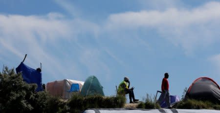 Migrants go on with their daily routine in the make-shift camp, called the jungle, in Calais, France, after Britain's referendum results to leave the European Union were announced June 24, 2016.    REUTERS/Pascal Rossignol