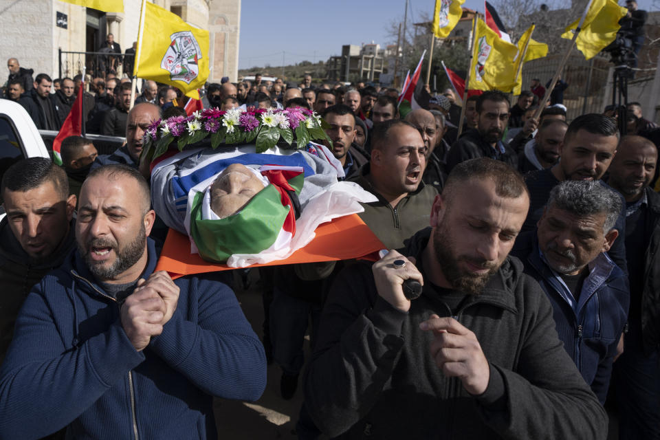 FILE - Mourners carry the body of 78-year-old Omar Asaad, a Palestinian who has U.S. citizenship, during his funeral in the West Bank village of Jiljiliya, north of Ramallah, Jan. 13, 2022. An autopsy, undertaken by three Palestinian doctors, confirmed that Asaad, who was pronounced dead shortly after being detained by Israeli troops in the occupied West Bank, died of a heart attack caused by “external violence.” (AP Photo/Nasser Nasser, File)