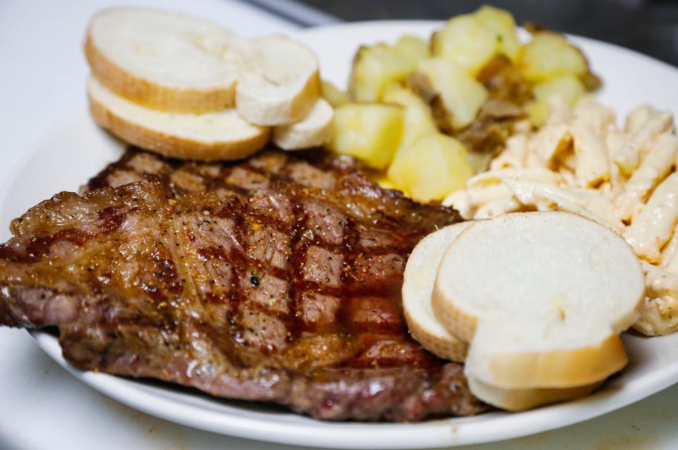 A steak meal with pasta salad, potatoes, and bread at Centerfold on Wednesday, May 31, 2023.