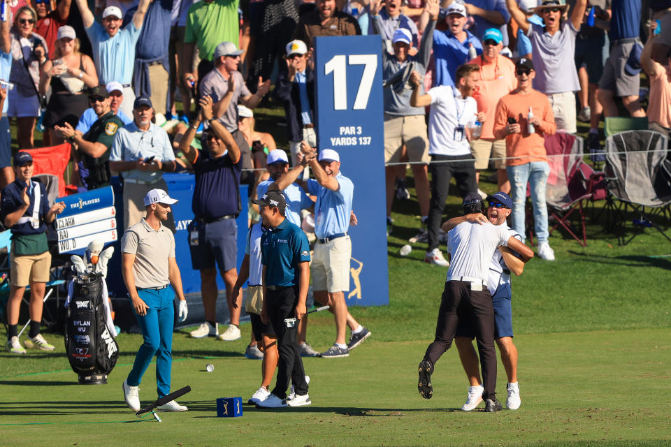 Rai hugs his caddie whilst the crowds celebrate