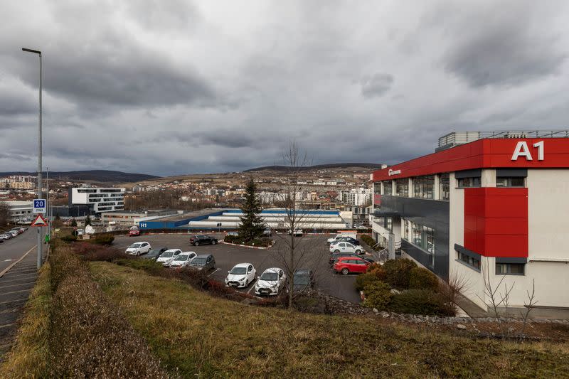 Cars are parked outside Tetarom Industrial Park, overlooking Cluj-Napoca