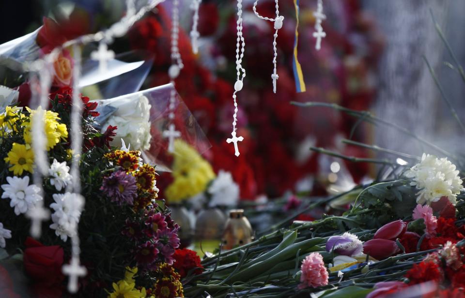 Flowers and rosaries are seen at the site where anti-Yanukovich protesters have been killed in recent clashes in Kiev
