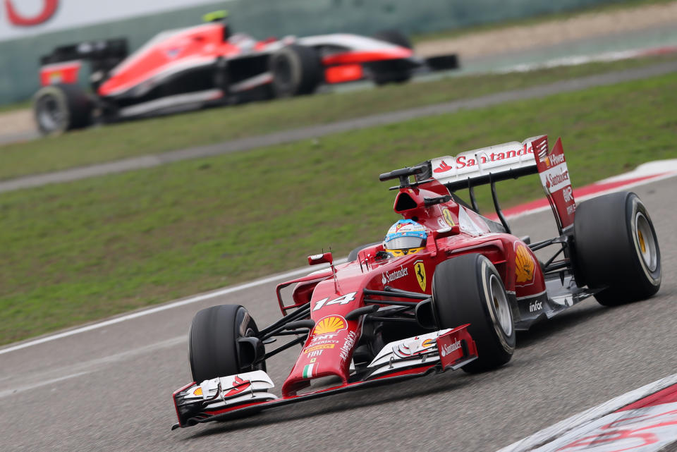 Ferrari driver Fernando Alonso of Spain, bottom, drives during the Chinese Formula One Grand Prix at Shanghai International Circuit in Shanghai, Sunday, April 20, 2014. (AP Photo/Eugene Hoshiko)