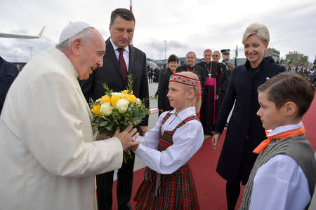 Pope Francis is welcomed at the airport in Riga, Latvia, during the second leg of his trip to the Baltic states, September 24, 2018. Vatican Media/Handout via REUTERS