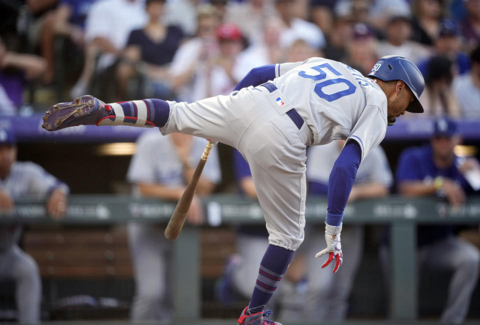 Los Angeles Dodgers' Mookie Betts spins out of the batter's box to avoid a high, inside pitch from Colorado Rockies starting pitcher Connor Seabold in the fourth inning of a baseball game Tuesday, June 27, 2023, in Denver. (AP Photo/David Zalubowski)