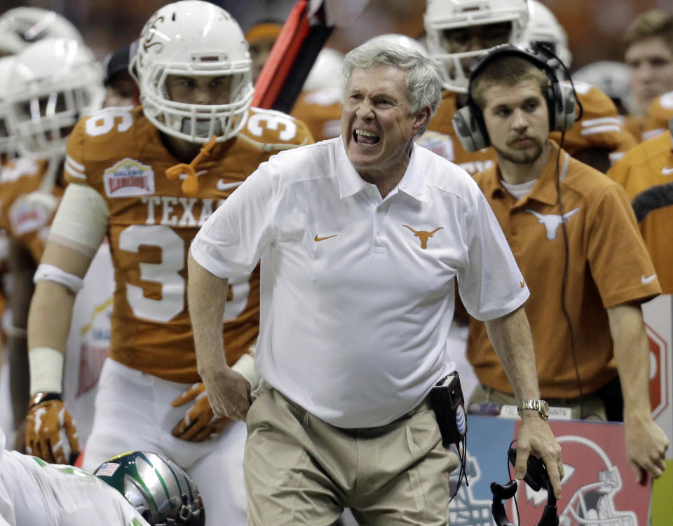 Texas coach Mack Brown, center, argues a call during the second half of the Valero Alamo Bowl NCAA college football game against Oregon, Monday, Dec. 30, 2013, in San Antonio. Brown has resigned and the game is his last. (AP Photo/Eric Gay)
