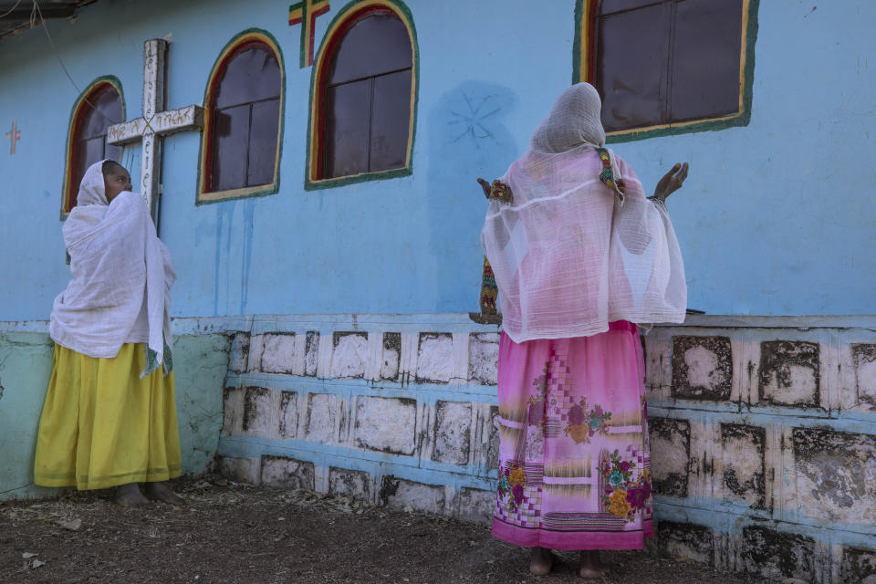 Tigrayan women who fled the conflict in Ethiopia's Tigray region, pray after Sunday Mass ends at a nearby church, at Umm Rakouba refugee camp in Qadarif, eastern Sudan, Nov. 29, 2020. (AP Photo/Nariman El-Mofty)