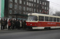 In this Saturday, Feb. 2, 2019 photo, people queue up to board a tram in Pyongyang, North Korea. Pyongyang is upgrading its overcrowded mass transit system with brand new subway cars, trams and buses in a campaign meant to show leader Kim Jong Un is raising the country's standard of living. (AP Photo/Dita Alangkara)