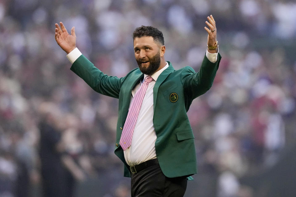 Golfer, Jon Rahm throws out the ceremonial first pitch before Game 4 of the baseball World Series between the Arizona Diamondbacks and the Texas Rangers Tuesday, Oct. 31, 2023, in Phoenix. (AP Photo/Brynn Anderson)