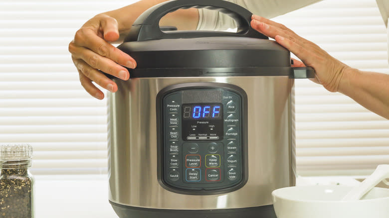 Opening instant pot in kitchen