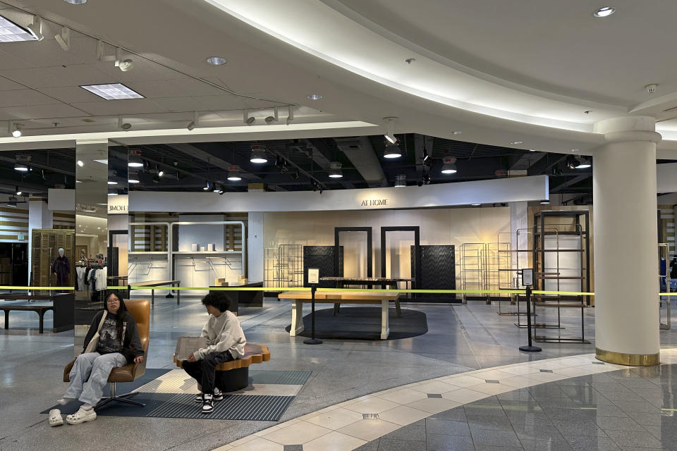 Two women sit outside an empty section of Nordstrom's at the Westfield San Francisco Centre shopping mall on June 21, 2023. San Francisco's downtown has seen an exodus of retailers and now a shopping mall owner is turning the complex over to its lender in the face of declining foot traffic and empty office space. While San Francisco faces some of its own unique issues the problems serve as warning signs for other downtowns across the country, which are also feeling some pain. (AP Photo/Eric Risberg)