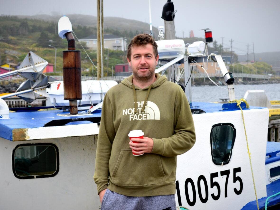 Andy Francis, pictured on the Port aux Basques wharf on Friday morning, is among the fishers preparing their boats for the incoming hurricane. (Malone Mullin/CBC - image credit)