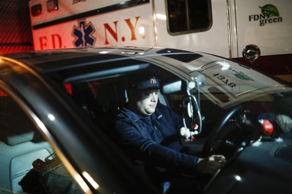 Paramedic Travis Kessel is photographed outside his station house after working a shift amid the COVID-19 pandemic, Monday, April 6, 2020, in the Bronx borough of New York. Kessel never imagined his work could hurt this much. He loves his career in emergency services. It's even how he met his wife, an emergency room nurse. But now he worries about the toll the new coronavirus is taking on both of them and their colleagues. (AP Photo/John Minchillo)