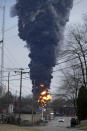 A black plume rises over East Palestine, Ohio, as a result of a controlled detonation of a portion of the derailed Norfolk and Southern trains Monday, Feb. 6, 2023. (AP Photo/Gene J. Puskar)