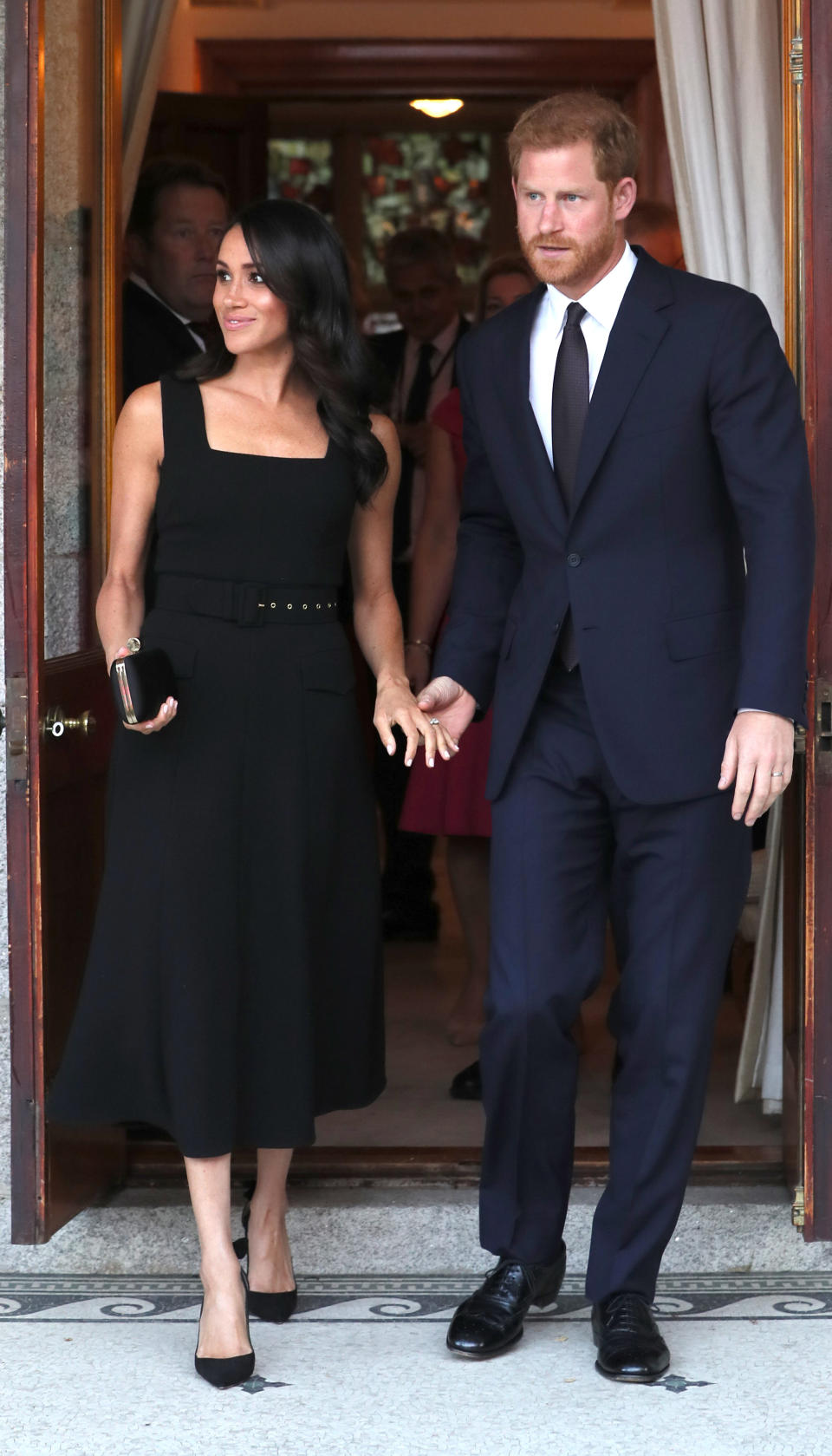 <p>For a summer garden party at Glencairn House on 10 July, the Duchess of Sussex changed into her third outfit of the day. In a surprising sartorial move, the royal opted for a belted dress by Emilia Wickstead and accessorised the look with a Givenchy clutch, Birks earrings and a pair of Aquazurra heels. <em>[Photo: PA]</em> </p>