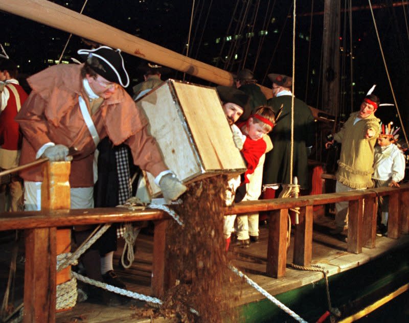 Re-enactors pour chests of tea into Boston Harbor from a ship at the Boston Tea Party Ship and Museum on December 13, 1998, to celebrate the 225th anniversary of the Boston Tea Party. On December 16, 1773, about 50 American patriots, protesting the British tax on tea, dumped 342 chests of it into Boston harbor. File Photo by Lee K. Marriner/UPI