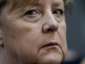 FILE - German Chancellor Angela Merkel looks on during the first plenary session of the German parliament Bundestag after the elections, Berlin, Oct. 26, 2021. Chancellor Angela Merkel on Saturday called on all unvaccinated Germans to get their shots as quickly as possible as the country’s coronavirus infection rate hits the latest in a string of new highs and death numbers are growing. (Photo/Markus Schreiber, File)