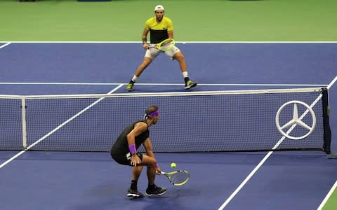 Rafa Nadal returns the ball at the net - Credit: ap