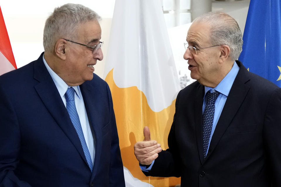 Cyprus' foreign minister Ioannis Kasoulides, right, talks with his Lebanese counterpart Abdallah Bou Habib before their meeting at the foreign ministry house in Nicosia, Cyprus, Friday, April 15, 2022. Bouhabib is in Cyprus for one-day visit. (AP Photo/Petros Karadjias)