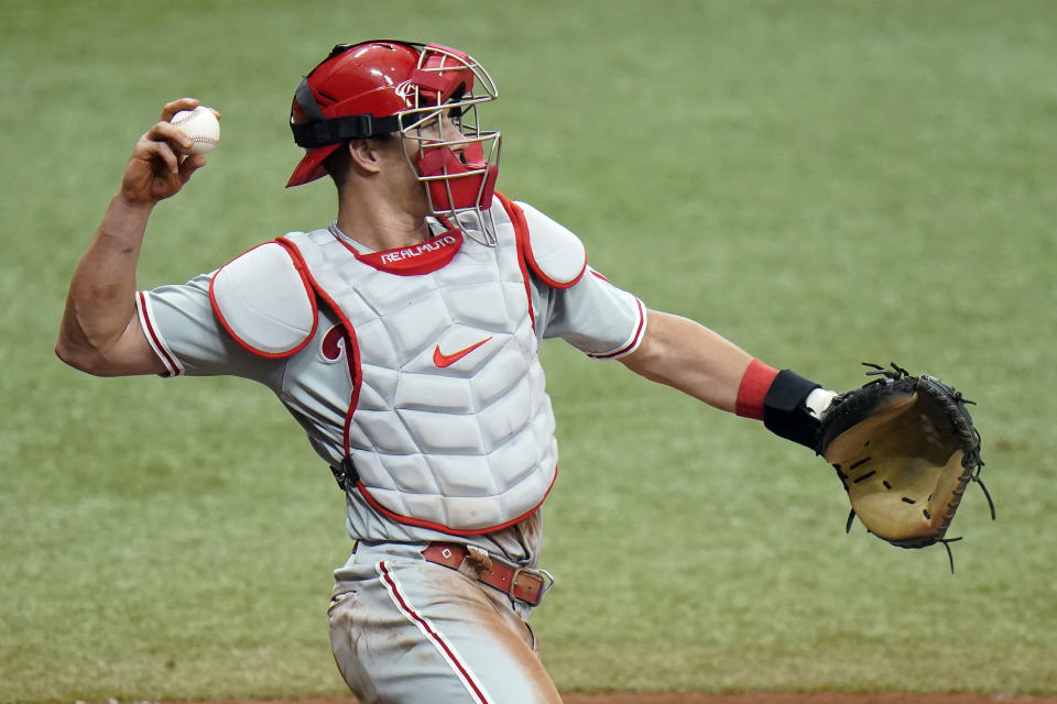 Philadelphia Phillies catcher J.T. Realmuto throws the ball back to starting pitcher Zack Wheeler while Tampa Bay Rays' Austin Meadows is at bat during the fourth inning of a baseball game Saturday, May 29, 2021, in St. Petersburg, Fla. Realmuto is back playing after an injury. (AP Photo/Chris O'Meara)