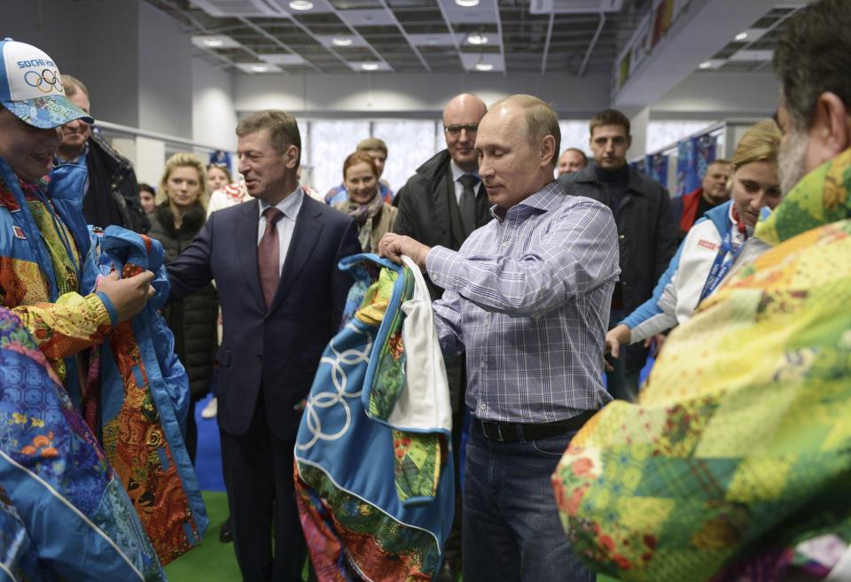 Russia's President Vladimir Putin (R), Organising Committee Head Dmitry Chernyshenko (C) and Deputy Prime Minister Dmitry Kozak (L) visit an Olympic volunteer's centre in Sochi January 4, 2014. REUTERS/Alexei Nikolskiy/RIA Novosti/Kremlin (RUSSIA - Tags: POLITICS SPORT OLYMPICS) ATTENTION EDITORS - THIS IMAGE HAS BEEN SUPPLIED BY A THIRD PARTY. IT IS DISTRIBUTED, EXACTLY AS RECEIVED BY REUTERS, AS A SERVICE TO CLIENTS