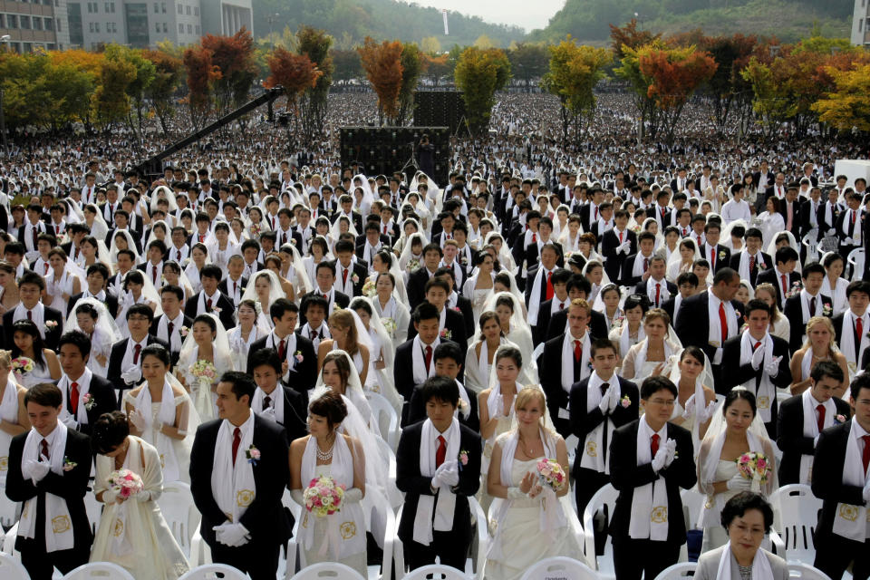 FILE - In this Wednesday, Oct. 14, 2009 file photo, couples from around the world participate in a mass wedding ceremony arranged by the Rev. Sun Myung Moon's Unification Church at Sun Moon University in Asan, south of Seoul, South Korea. Moon, self-proclaimed messiah who founded the Unification Church, has died at age 92 church officials said Monday, Sept. 3, 2012. (AP Photo/Lee Jin-man)