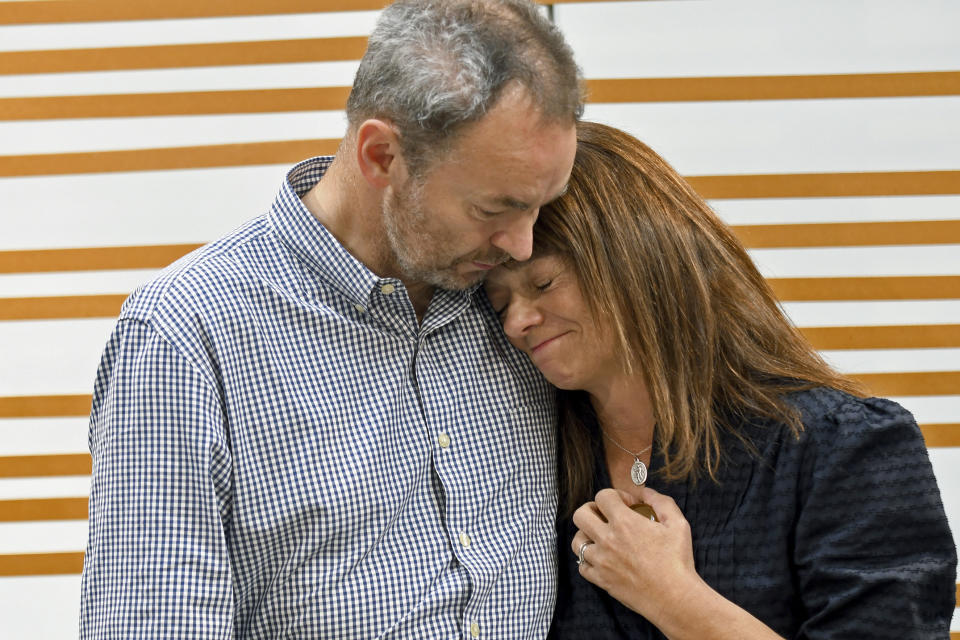 FILE - Simon and Sally Glass comfort each other during an emotional news conference in Denver on Sept. 13, 2022. Two Colorado sheriff’s deputies needlessly escalated a fatal standoff with their son, Christian Glass, who was shot and killed while experiencing a “mental health crisis.” As part of a $19 million settlement this spring 2023 with Glass’ parents, Colorado’s Clear Creek County in August 2023 joined a growing roster of U.S. communities that respond to nonviolent mental health crises with clinicians and EMTs or paramedics, instead of police. (AP Photo/Thomas Peipert, File)