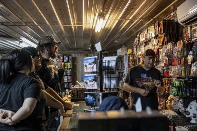 Customers peruse various horror movie decorations and memorabilia at We Slaughter BBQ. The location, originally featured in the 1974 horror film "Texas Chainsaw Massacre," has now been turned into a tourist attraction and horror museum.