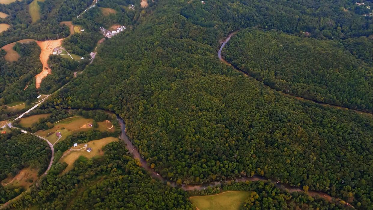 The Dan River in North Carolina is seen snaking through the forest below as I fly over. The Dan River flows 214 miles in North Carolina and Virginia. It rises in Patrick County, Virginia, and crosses the state border into Stokes County, North Carolina. It then flows into Rockingham County. From there it back into Virginia through only Pittsylvania County before reentering North Carolina near the border between Caswell County and Rockingham County. It flows into northern Caswell County and then back into southern Virginia (briefly Pittsylvania County, then into Halifax County) and finally into Kerr Reservoir on the Roanoke River.