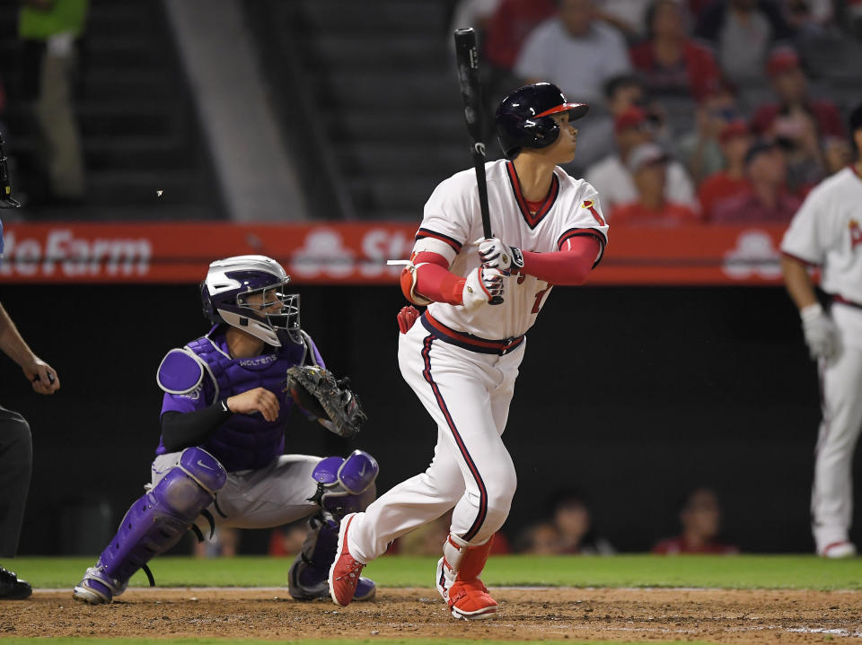 Los Angeles Angels' Shohei Ohtani, right, of Japan, hits a three-run home run as Colorado Rockies catcher Tony Wolters watches during the fourth inning of a baseball game Monday, Aug. 27, 2018, in Anaheim, Calif. (AP Photo/Mark J. Terrill)