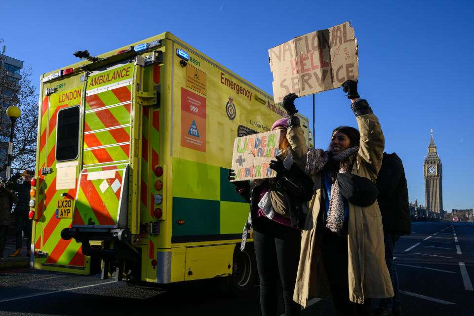LONDON, ENGLAND - DECEMBER 15: An ambulance drives past as nurses and supporters gather to demonstrate outside St Thomas' hospital in Westminster on December 15, 2022 in London, England. Nurses in England, Wales and Northern Ireland have begun the first of two day-long strikes over pay and working conditions, with a second taking place on 20 December. (Photo by Leon Neal/Getty Images)
