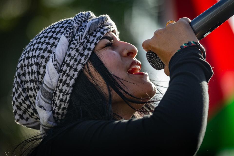 Donia Elktahib, West Palm Beach, leads a chant during a Palestinian rally on the grassy median on Okeechobee Boulevard between Florida and Alabama avenues in downtown West Palm Beach, on Sunday, Nov. 19, 2023.